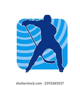 Silhouette of an ice hockey player wearing helmet and uniform carrying hockey stick in action pose