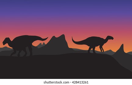 Silhouette of Iguanodon in hills at the afternoon