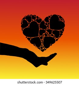 silhouette image of the hand on which is situated in the heart of an abstract background of a smooth transition of colors from red to yellow