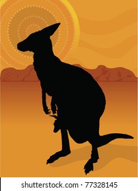 A silhouette of a kangaroo with her joey on a background of the outback with an aboriginal sun.