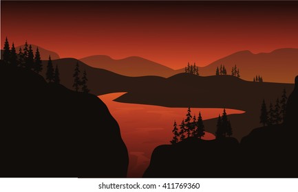 Silhouette of lake with brown backgrounds at the sunrise