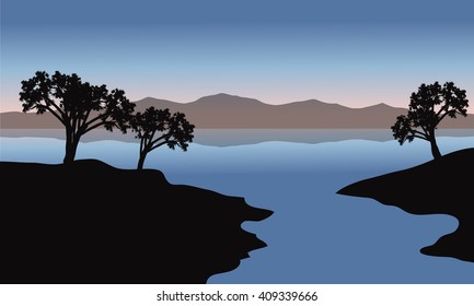 Silhouette of lake and trees with blue backgrounds