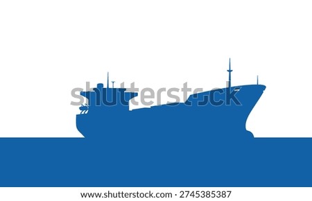 Silhouette of a large cargo ship sailing on the ocean at sunrise