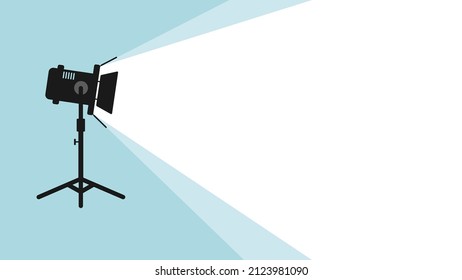 Silhouette of light lamp projector on a tripod with scattered rays. Cinema movie festival poster. Cinema background. Spotlight is glowing on wall. Spotlight icon in flat style. Movie time concept.