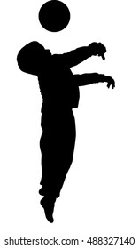 Silhouette of little boy with ball playing football