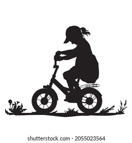 Silhouette of a little girl on a bicycle