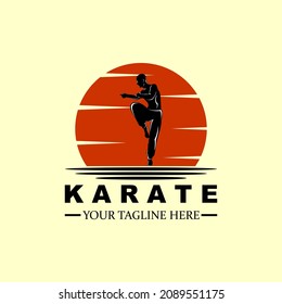 A silhouette logo of a karate master at dusk.