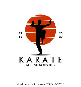 A silhouette logo of a karate master at dusk.