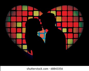 Silhouette of lovers in front of the luminous mosaic heart shaped window