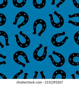 Silhouette of a lucky horseshoe. Seamless vector pattern. Endless ornament. Isolated blue background. Horse shoes. Imitation of ink drawing. St. Patrick's day. Flat style. Idea for web design, cover