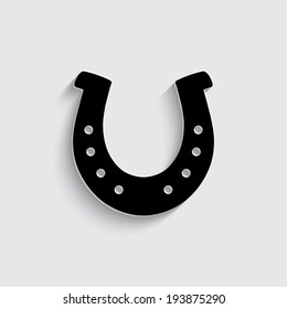 silhouette lucky horseshoe with shadow on a grey background