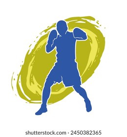 Silhouette of male boxing athlete in action pose. Silhouette of a muscular man wearing boxing gloves for boxing sport.