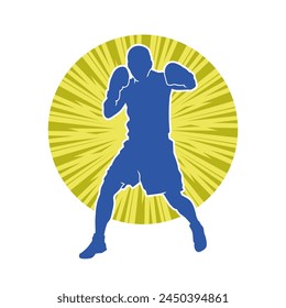 Silhouette of male boxing athlete in action pose. Silhouette of a muscular man wearing boxing gloves for boxing sport.