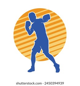 Silhouette of male boxing athlete in action pose. Silhouette of a muscular man wearing boxing gloves for boxing sport.