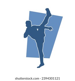Silhouette of a male kickboxing athlete in action pose. Silhouette of a kickboxer man doing martial art pose.