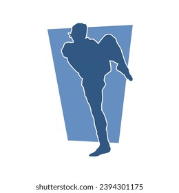 Silhouette of a male kickboxing athlete in action pose. Silhouette of a kickboxer man doing martial art pose.