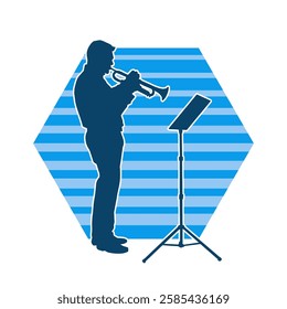 Silhouette of a male musician playing trumpet musical instrument.  Silhouette of a performing musician