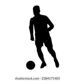 Silhouette of a male soccer player kicking a ball. Silhouette of a football player in action pose.