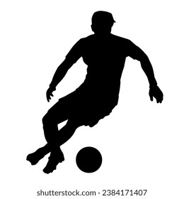 Silhouette of a male soccer player kicking a ball. Silhouette of a football player in action pose.