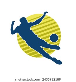 Silhouette of a male soccer player kicking a ball. Silhouette of a football player in action pose.