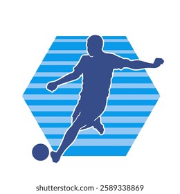 Silhouette of a male soccer player kicking a ball. Silhouette of a football player in action pose.