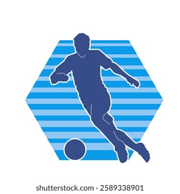 Silhouette of a male soccer player kicking a ball. Silhouette of a football player in action pose.