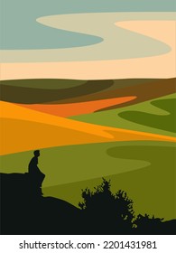 Silhouette of a man against the backdrop of an autumn landscape with fields.