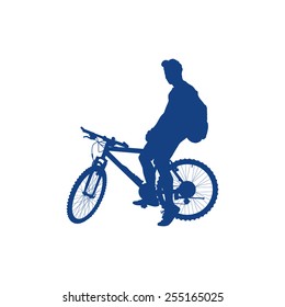 Silhouette of a man with a backpack on a bicycle