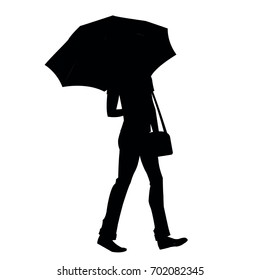 Silhouette of a man with a bag under an umbrella