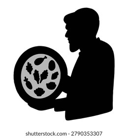 Silhouette of a man with a beard holding a plate of food containing vegetables and meat.