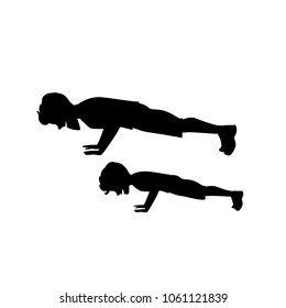 silhouette of man and boy father and son doing push ups workout