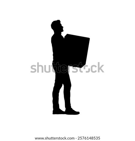 Silhouette of a man carrying a heavy box in front of him