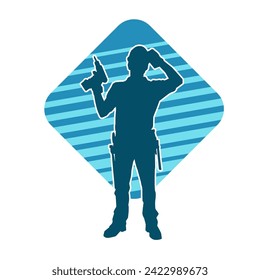 Silhouette of man in construction worker costume carrying drill power tool. Silhouette of construction worker male in action pose with power tool driller. 