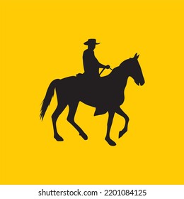 silhouette of man in cowboy hat riding a horse