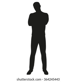 Silhouette of man with folded arms and legs apart. Vector silhouette of a young successful man with tilted head