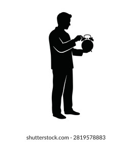 Silhouette of a man holding an alarm clock