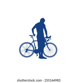 Silhouette of man holding a bicycle