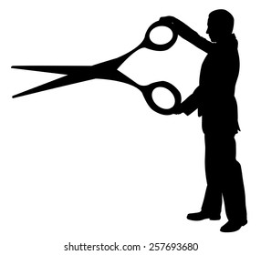 silhouette of a man holding a big pair of scissors