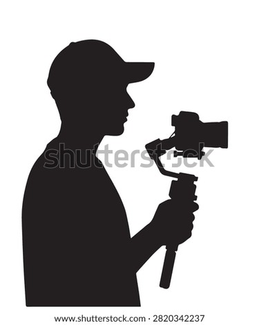 Silhouette of a man holding a camera with a motorized gimbal stabilizer for smooth video recording and vlogging.