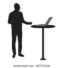 Silhouette of a man making presentation with a head microphone