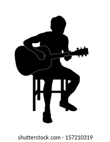 Silhouette of a man playing an acoustic guitar