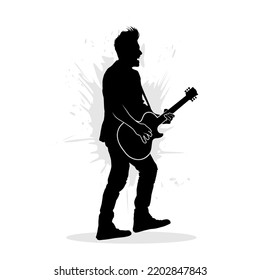 Silhouette of man playing guitar on stage