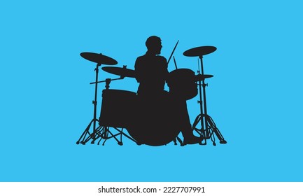silhouette of man playing music drums