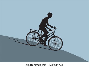 Silhouette of a man riding a bike