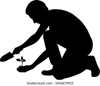 Silhouette Of Man With Shovel And Plant In Hand