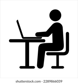 silhouette of a man sitting at a desk with a laptop