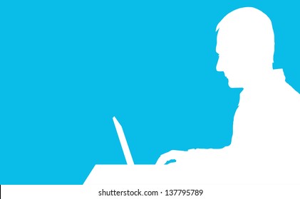 A silhouette of a man sitting at a laptop computer