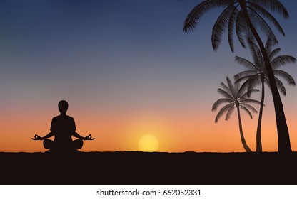 Silhouette of a man sitting and meditating on the beach under sunset sky background