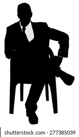 Silhouette of a man sitting in a modern armchair with one leg over his knee 