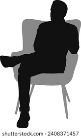 silhouette man sitting on armchair